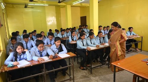 Teacher guiding students in a classroom